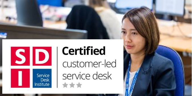 Graphic of service desk institute three star accreditation and person at a computer